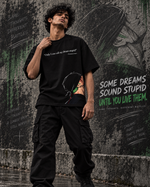 RUZE Against Doubt black oversized graphic T-shirt — male back view rainy street backdrop