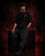 RUZE Shadow Speaks black oversized T-shirt seated lifestyle editorial