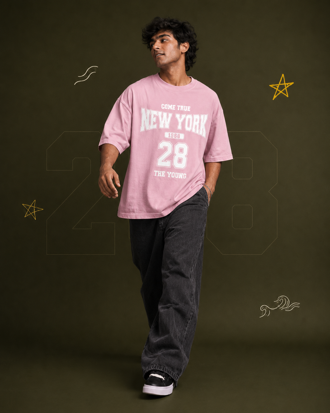 District 28 baby pink oversized T-shirt on male model – seated lifestyle