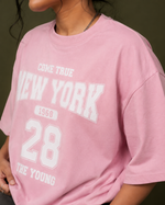 District 28 baby pink oversized T-shirt on female model – front standing